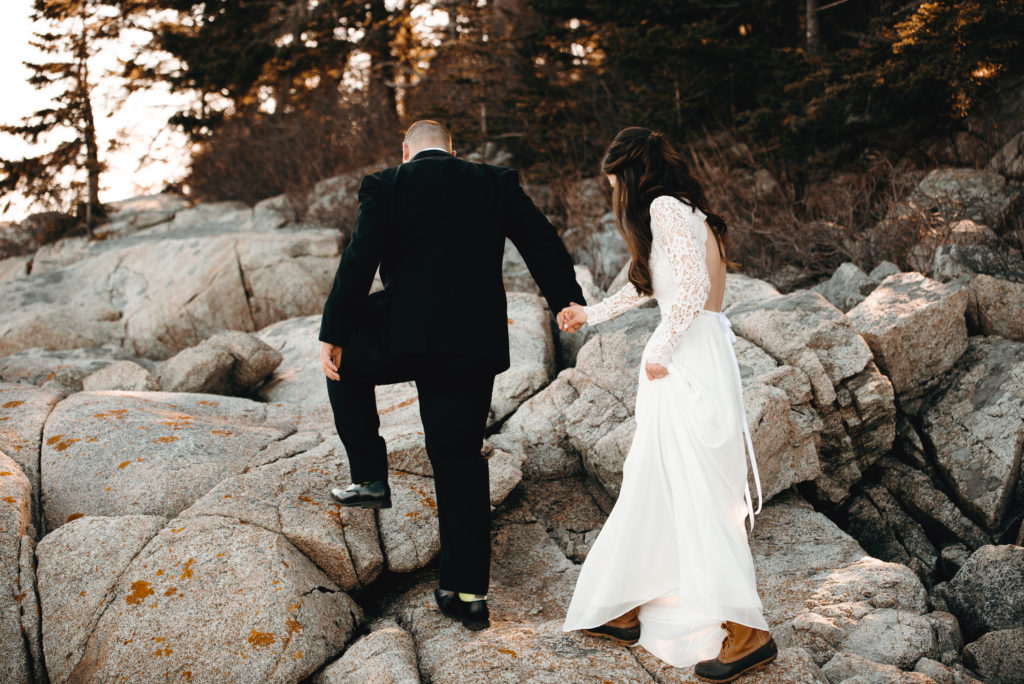 Bride and groom are holding hands and walking together, groom leads. Owls Head, Maine elopement. Midcoast Maine wedding photographer. Maine elopement photographer. Maine adventure photographer.